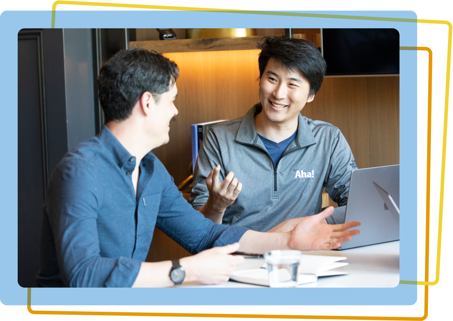 Two men working together on a laptop